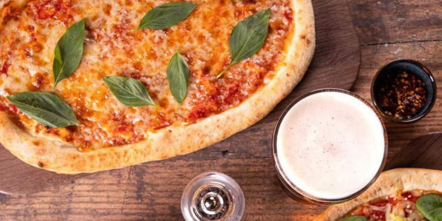 Margherita pizza with a pint